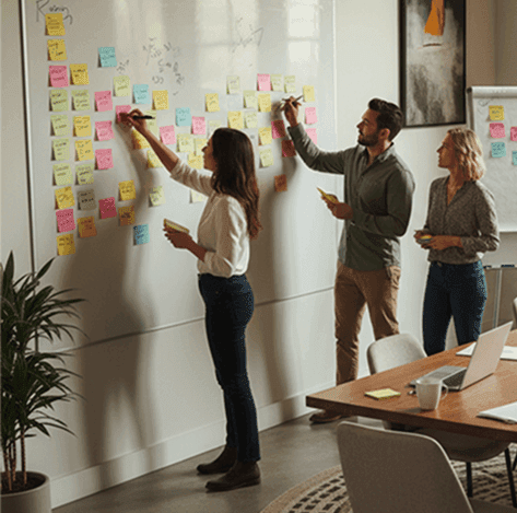 Team arranging sticky notes on a board during a co-creation workshop